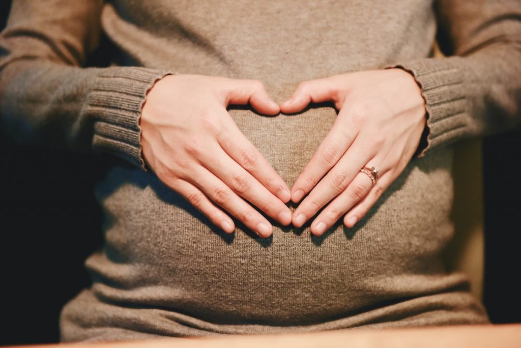 heart over pregnant woman's stomach