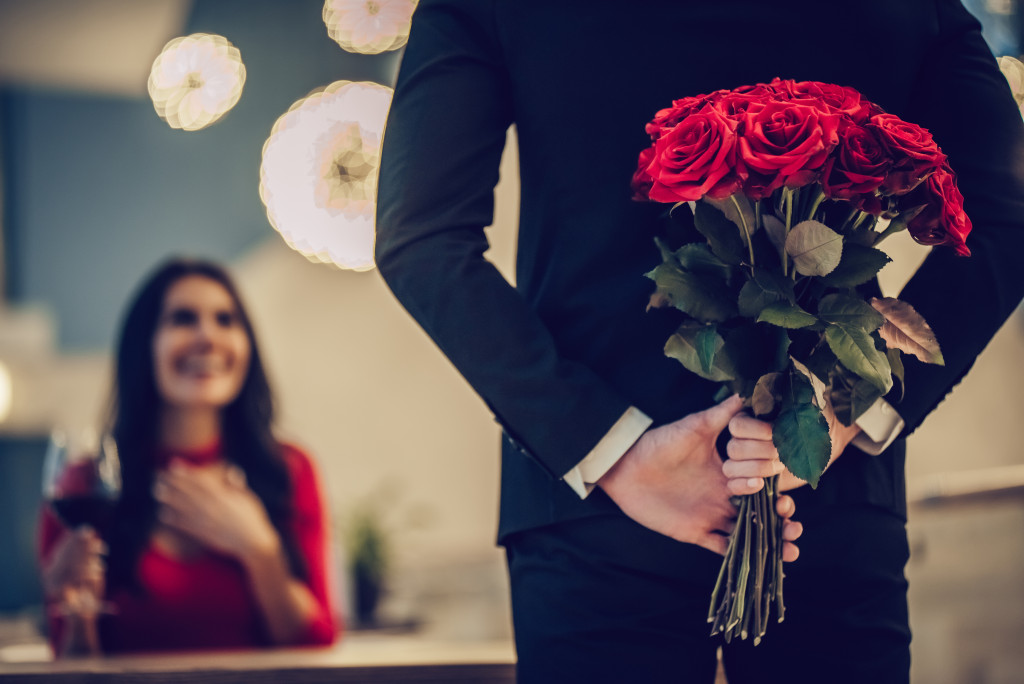 man with flowers to surprise his date