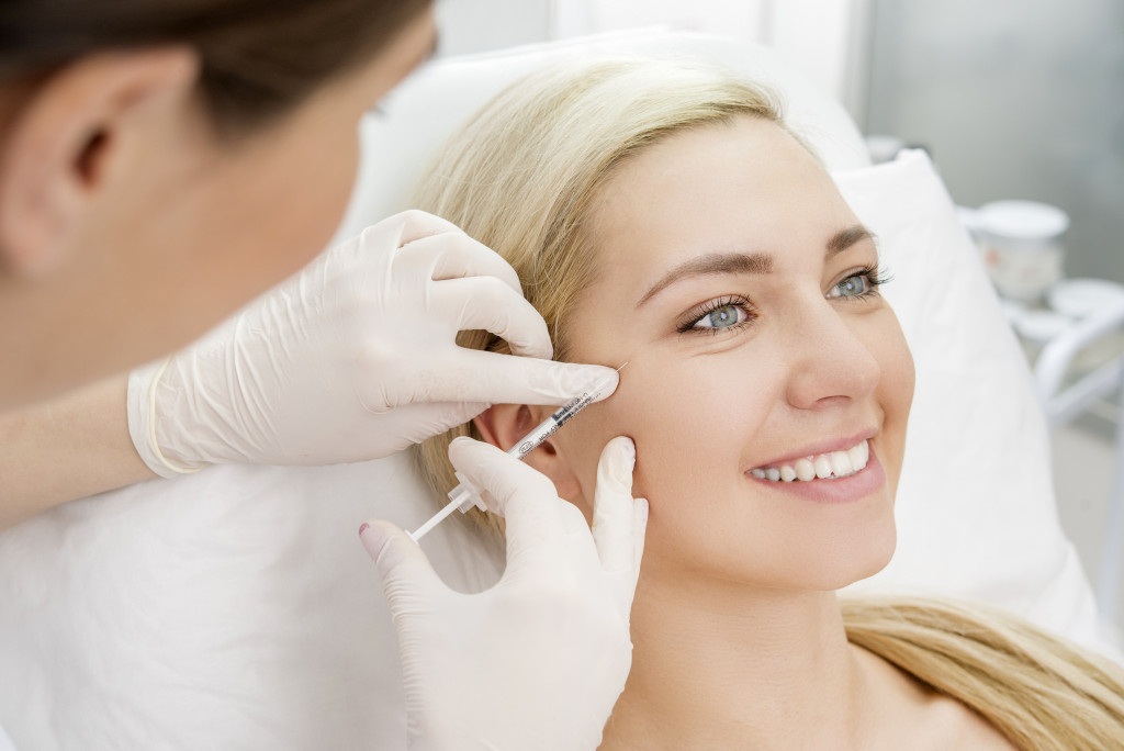 A woman getting dermal fillers at a clinic