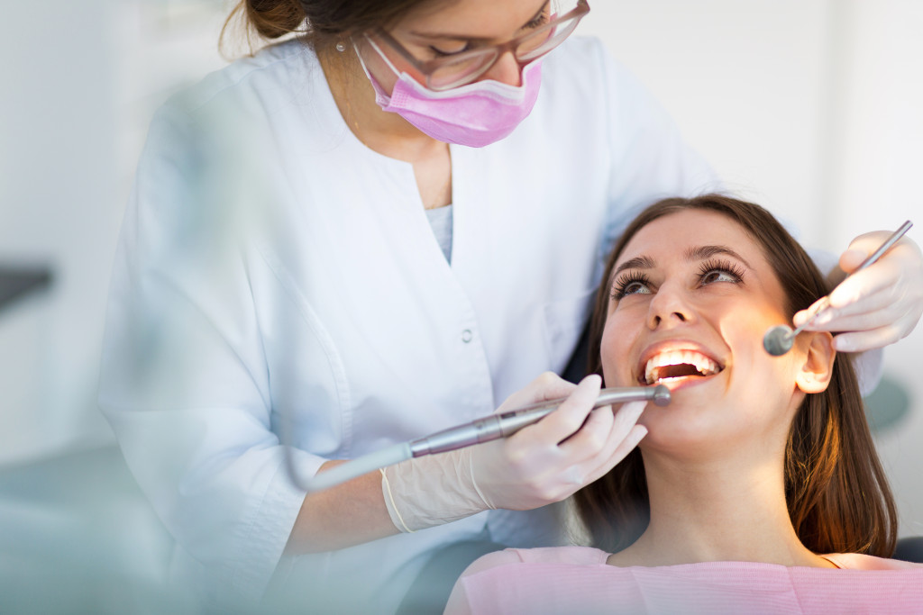 a woman in a dental chair while having a dental enhancement procedure