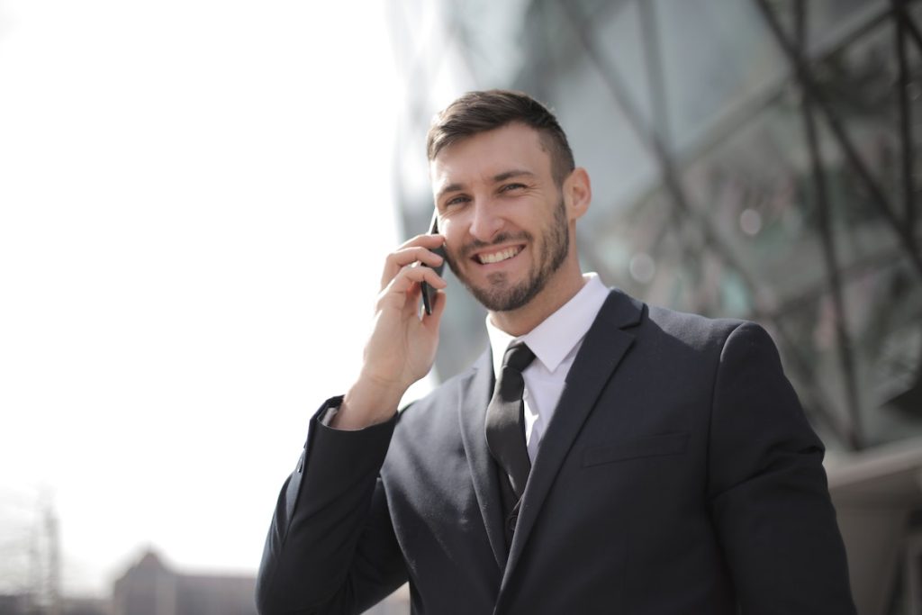man wearing black suit while on call