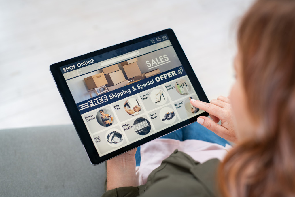 Young woman using a tablet while shopping online.