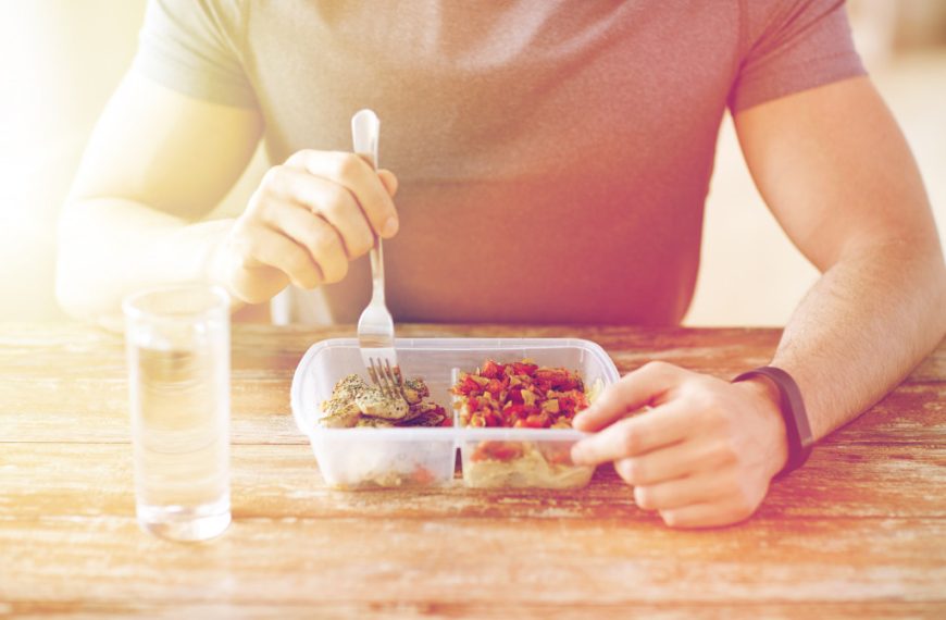 man healthy eating in a table with glass of water