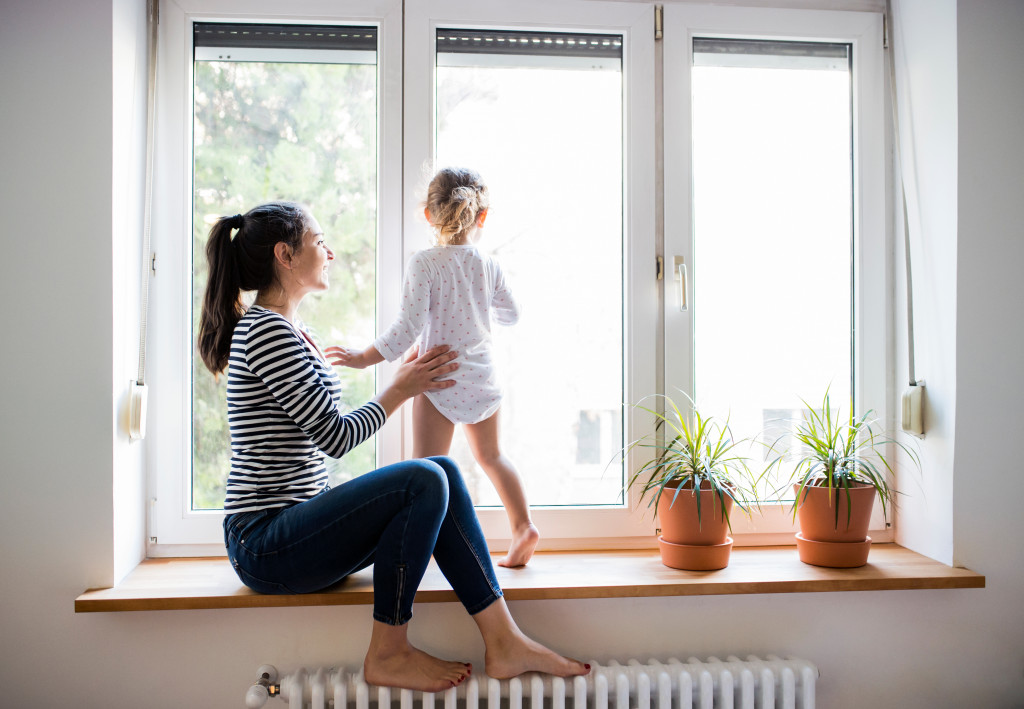 A mother and daughter by the window